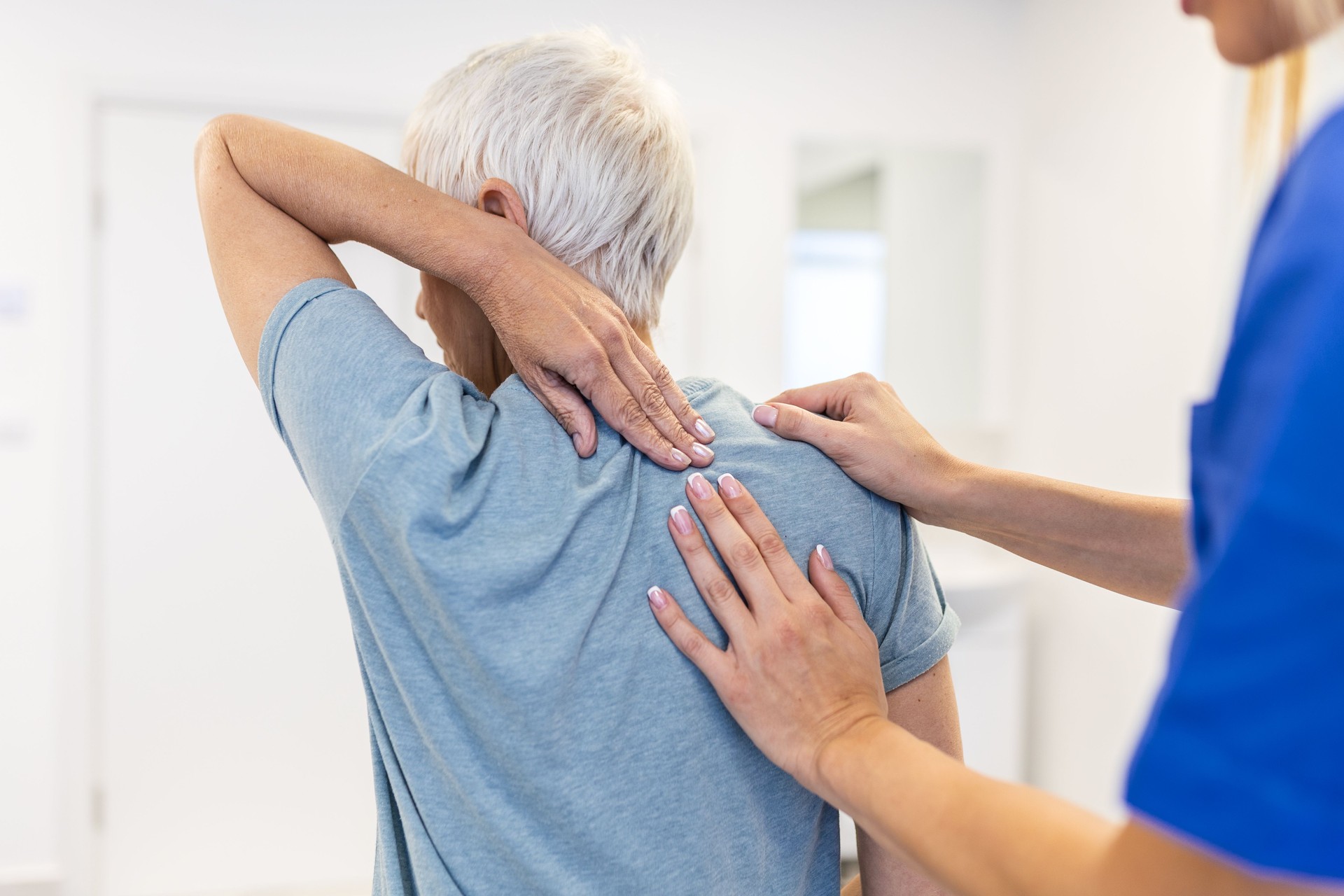 Physiotherapist doing healing treatment on woman's back. Back pain patient, treatment, Doctor consulting with patient Back problems Physical therapy concept