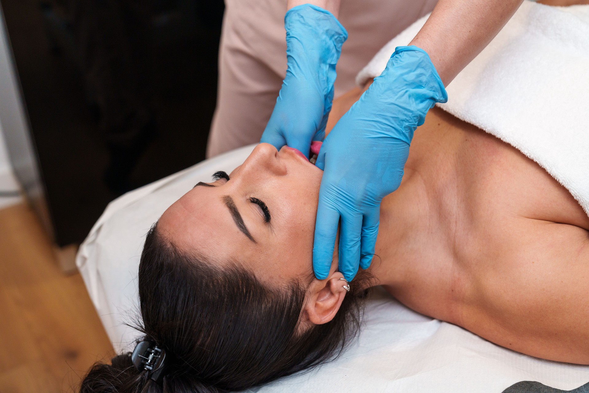Therapist Conducting TMJ Manual Therapy on Patient's Mandible